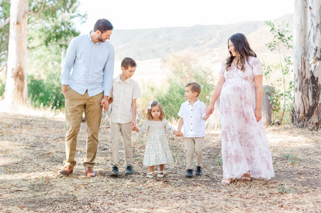 the whole family is walking and holding hands.