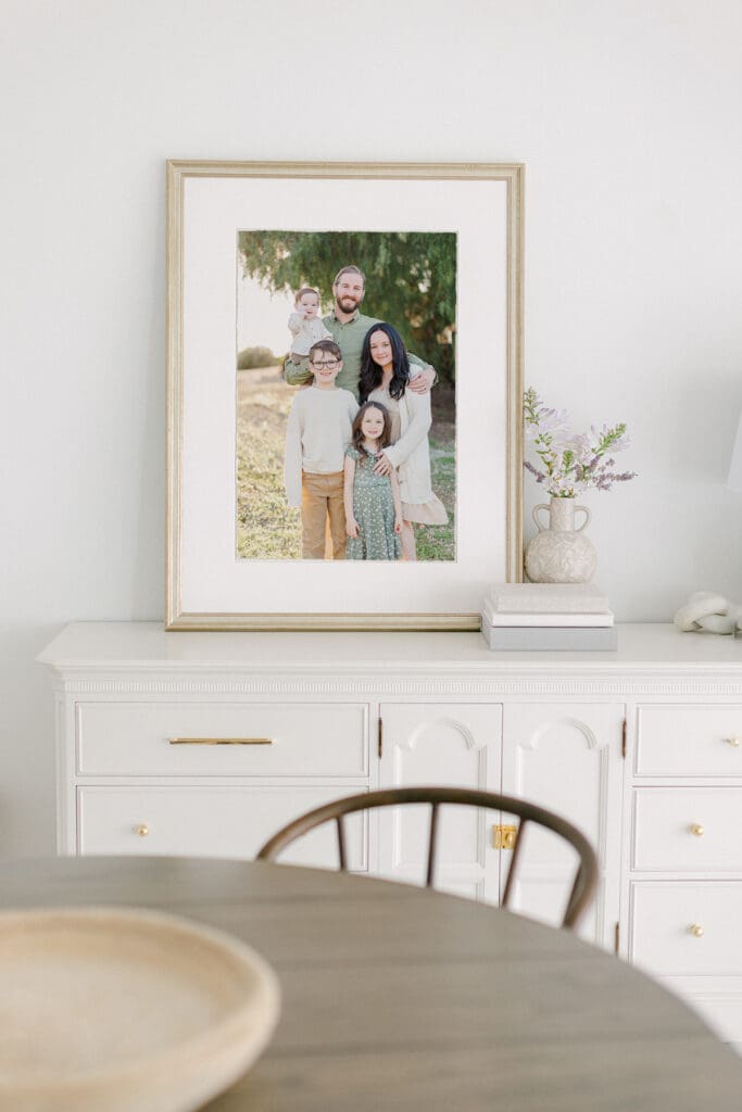 portrait of a family in a matted frame sitting on top of a white dresser