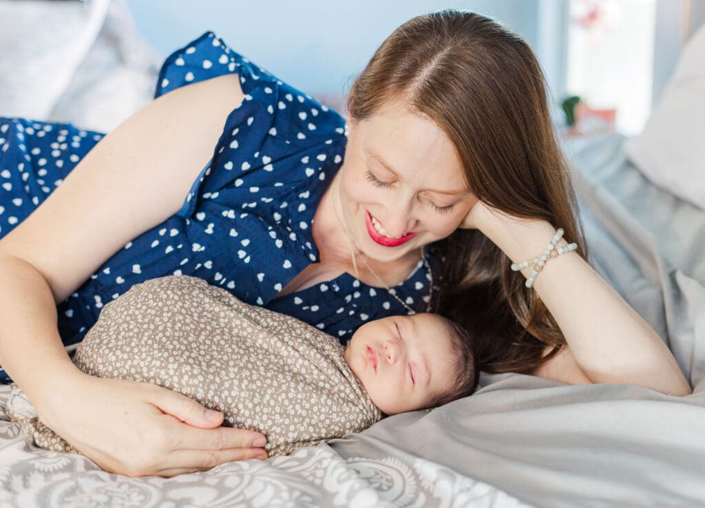 mom laying next to her newborn baby