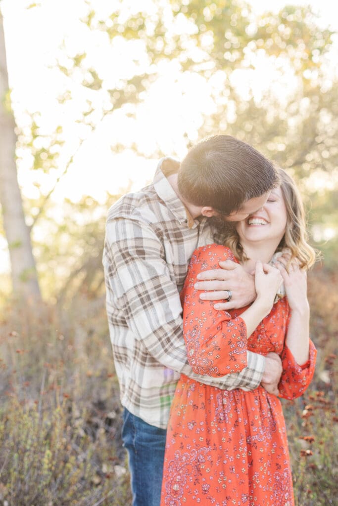 Authentic moment of a husband and wife laughing during a dinner date in Murrieta, highlighting connection over perfection.