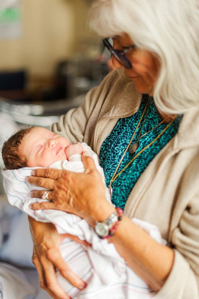 An newborn session in the hospital using natural light to highlight the beginning of motherhood.